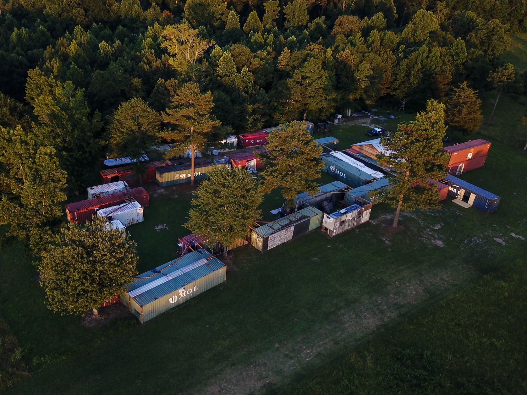 Aerial view of shipping container haunted house complex in the woods